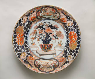 Imari-style Dish Decorated with a Vase of Flowers on a Table